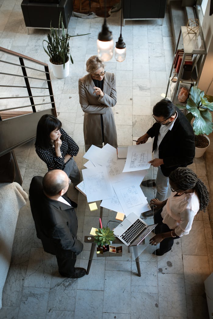 services-01 A team of professionals engage in a business meeting in a sleek, modern office setting.